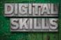 digital skills phrase made from metallic letterpress blocks on green pc board