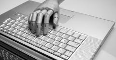 robot hand on keyboard
