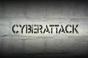 the word cyberattack written on a wall