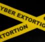 Yellow barricade tape with the words cyber extortion
